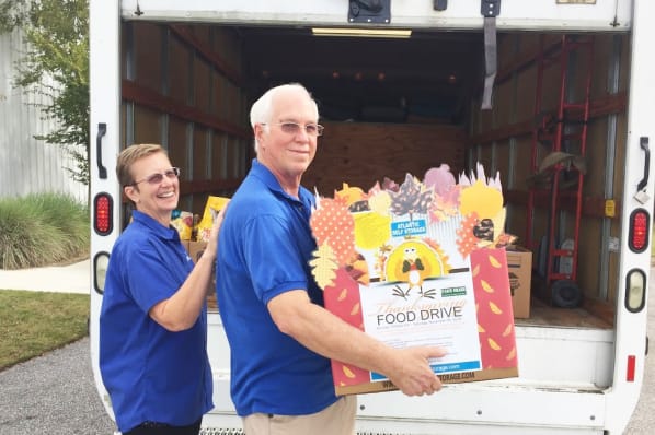Atlantic Self Storage employees loading food drive donations into a truck