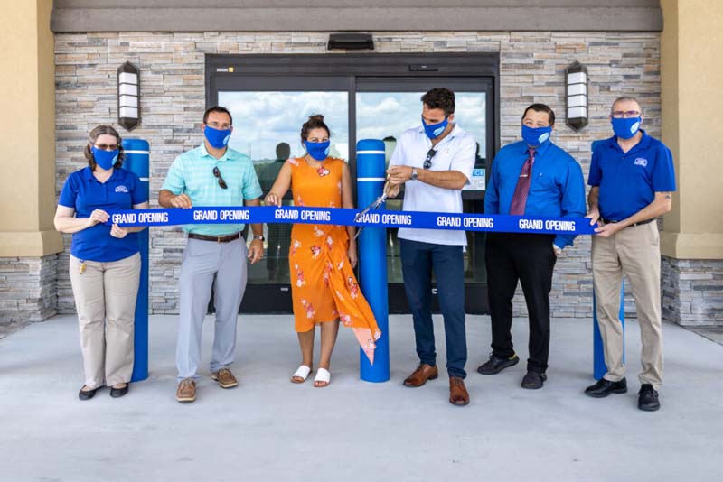 Atlantic Self Storage employees cutting the grand opening ribbon at a new storage facility